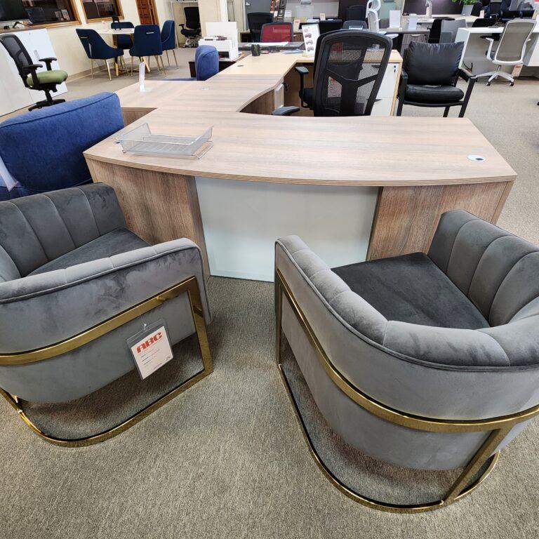 Client-facing view of the Ryker L-shaped desk with a bow front and glass modesty panel.